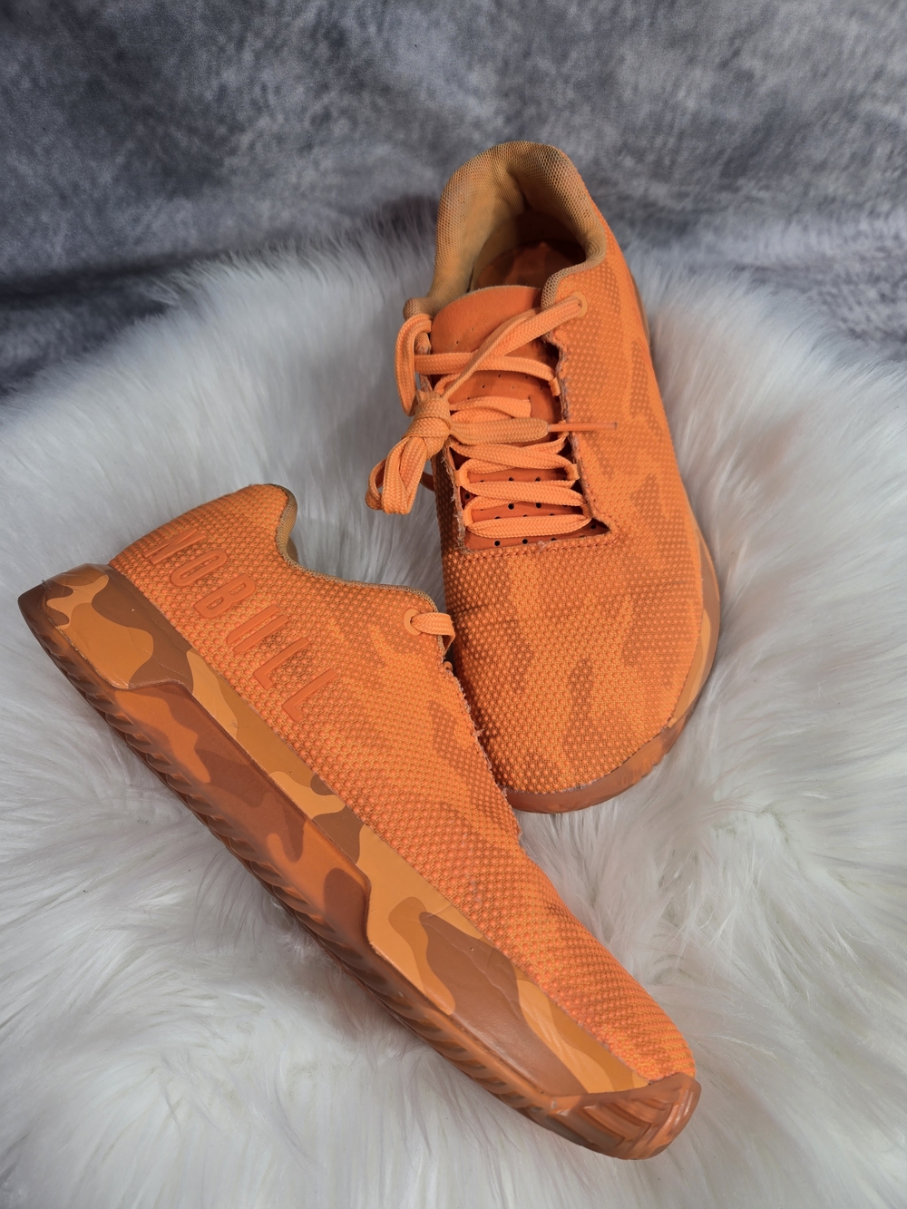 NOBULL Neon Orange Camo Low-Top Trainers.